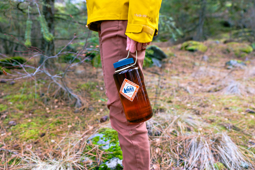 Woman holding an REI nalgene water bottle