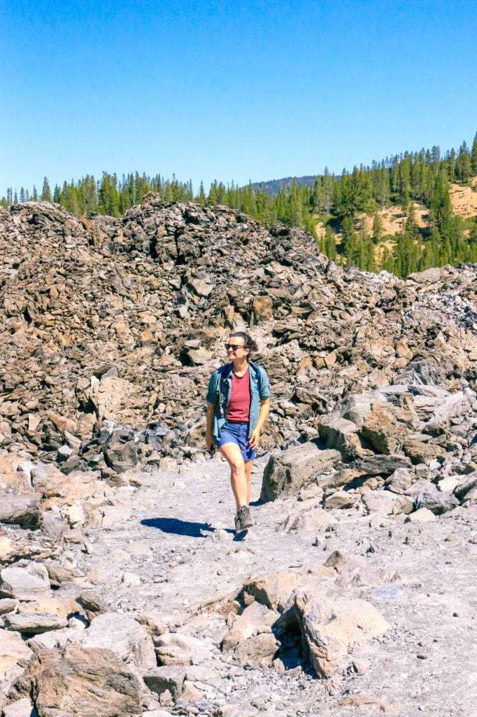 Woman hiking at Big Obsidian Flow at Newberry National Monument in Bend, Oregon