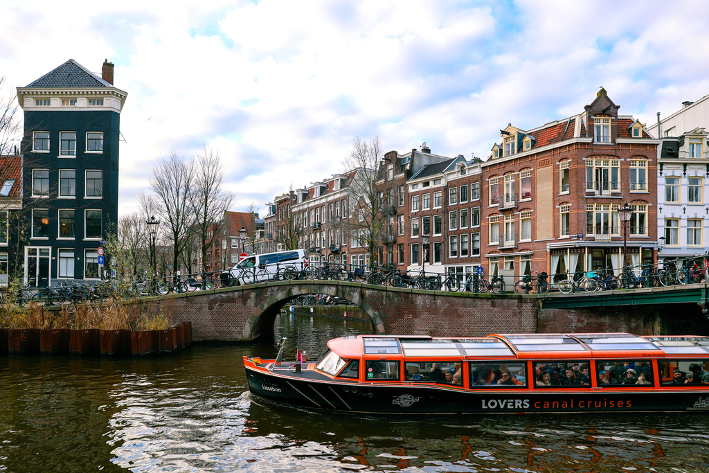 Amsterdam canals in the winter with a Lovers Canal Cruise boat passing by