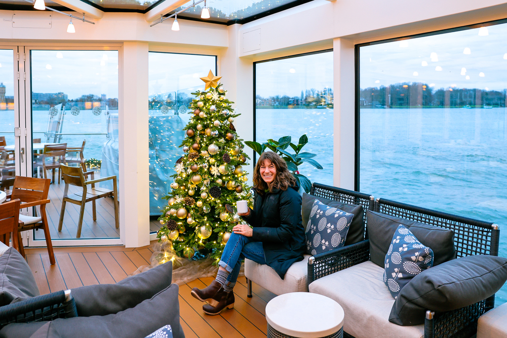 Woman sitting in the Aquavit terrace aboard a viking river cruise on the Christmas on the Rhine sailing