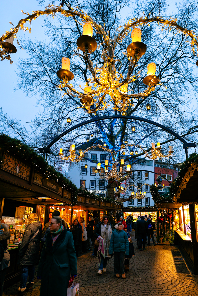 Bright lights and vendor stalls in a festive Christmas Market in Cologne, Germany