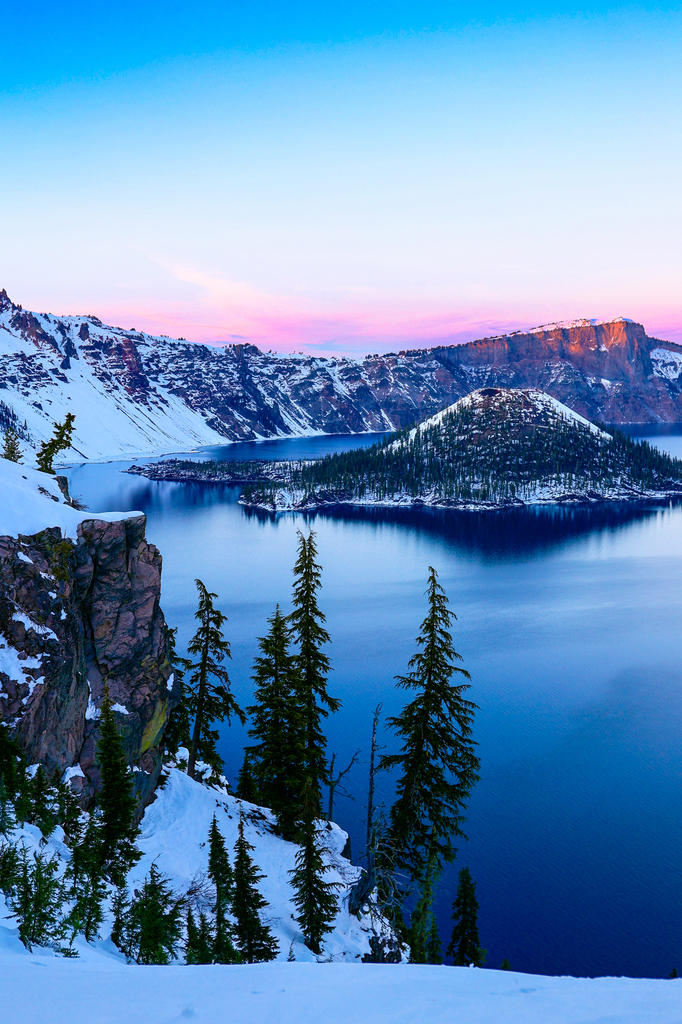 Visiting crater Lake National Park in winter. Wizard island in the snow.