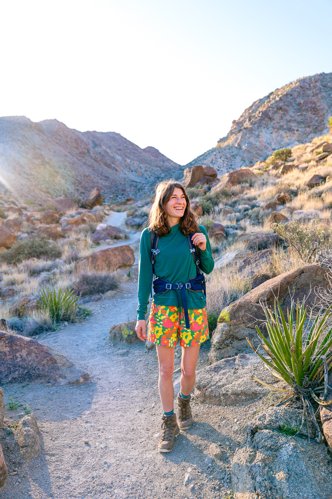 Woman hiking along the Fortynine Palms Oasis Trail at sunrise
