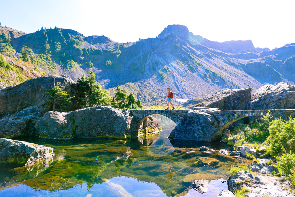 Woman walking along the iconic chain lakes trail in Mt. Baker Wilderness