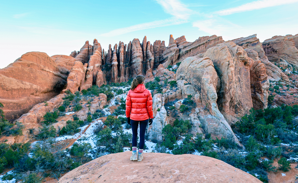 Woman standing looking at the rocks along the primitive section of the Devils Garden trail in arches national park