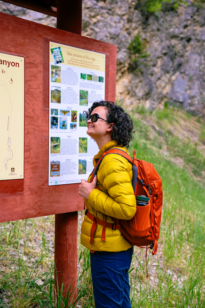 Woman wearing an REI 650 Down Jacket for a spring hike