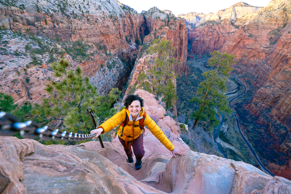 Woman hiking the chains section of Angels landing in Zion national park