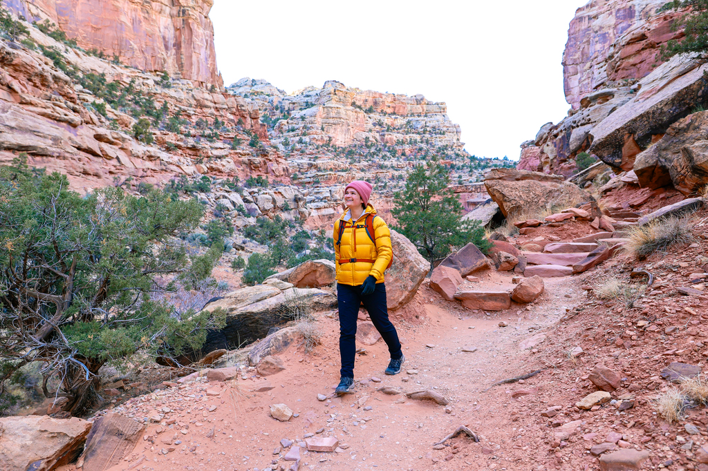 Woman hiking at Capitol reef national park along the Cassidy Arch Trail