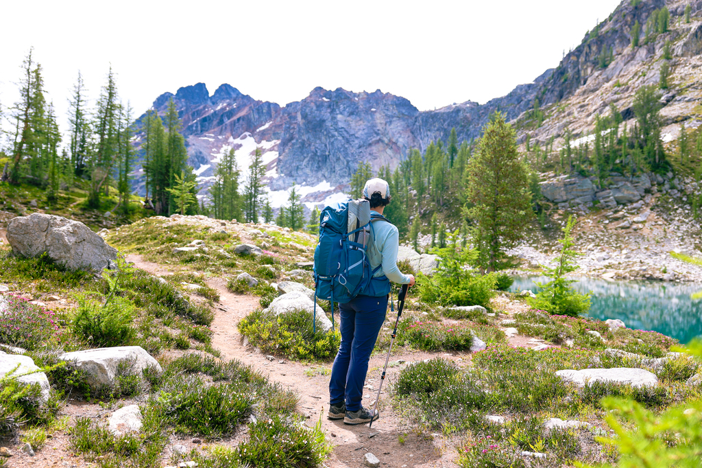 Woman backpacking at wing lake in the north cascades