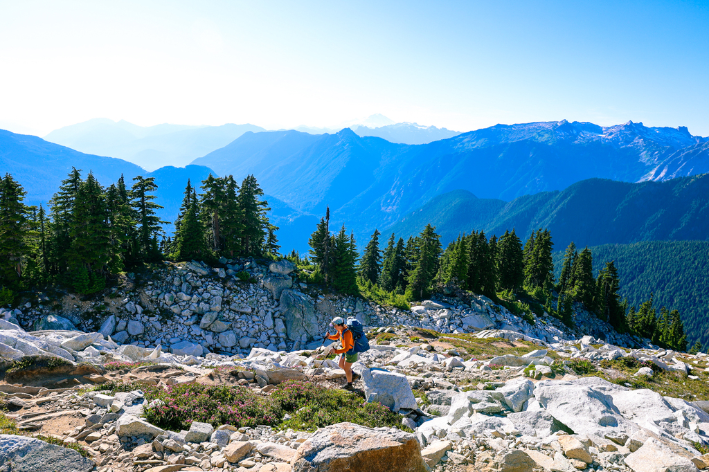 Woman hiking Hidden Lake Lookout hike in summer in Washington state North Cascades National Park