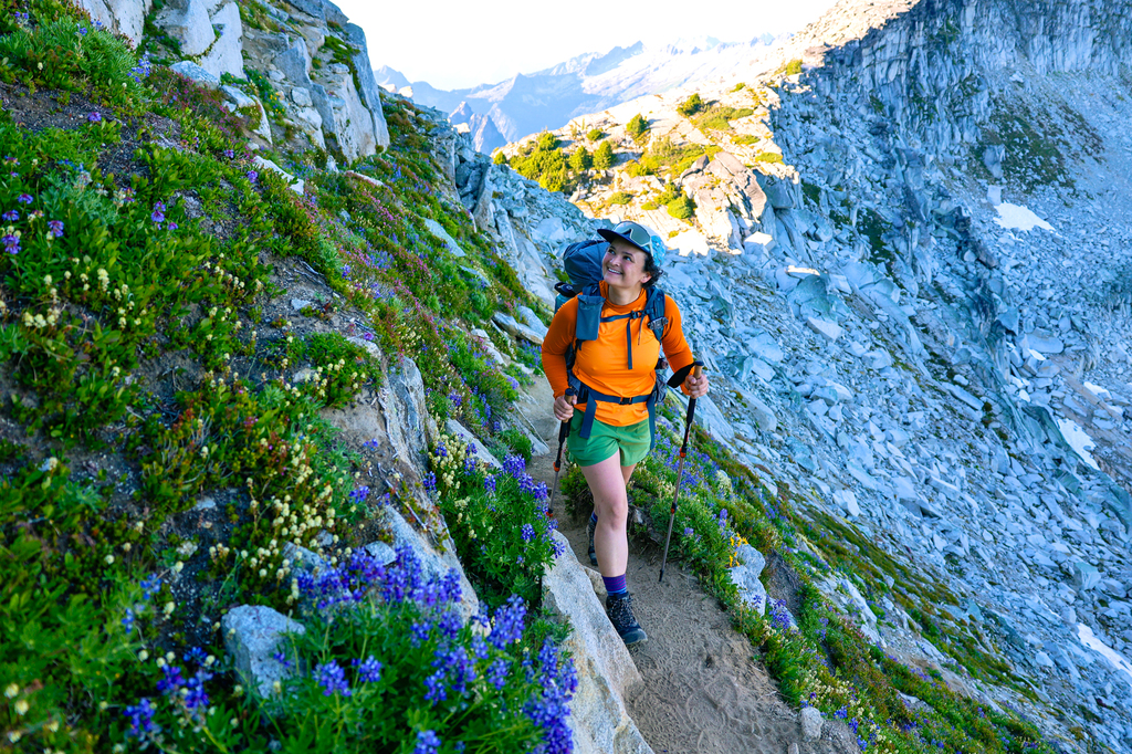 Woman hiking Hidden Lake Lookout hike in summer in Washington state North Cascades National Park